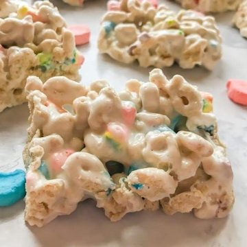 Lucky Charms Marshmallow Treats laying on a white marble countertop.