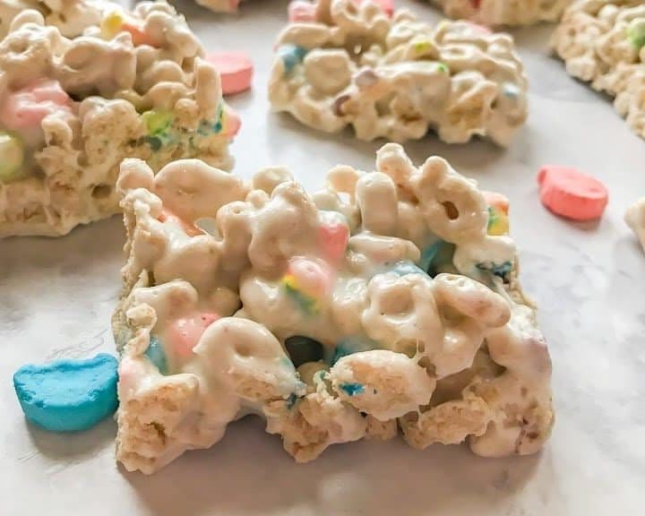 Lucky Charms Marshmallow Treats laying on a white marble countertop.