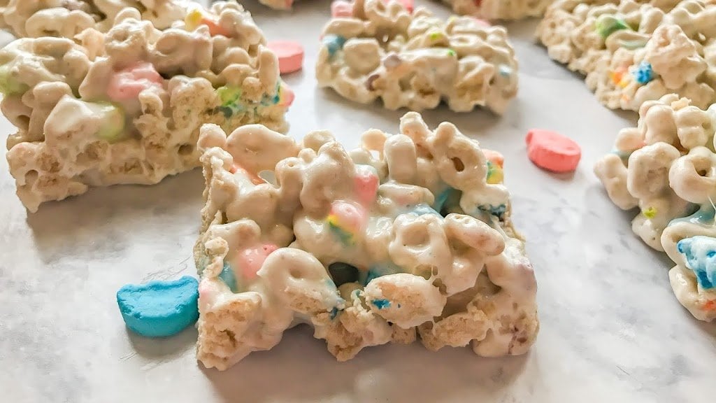 Lucky Charms Marshmallow Treats laying on a white marble countertop.