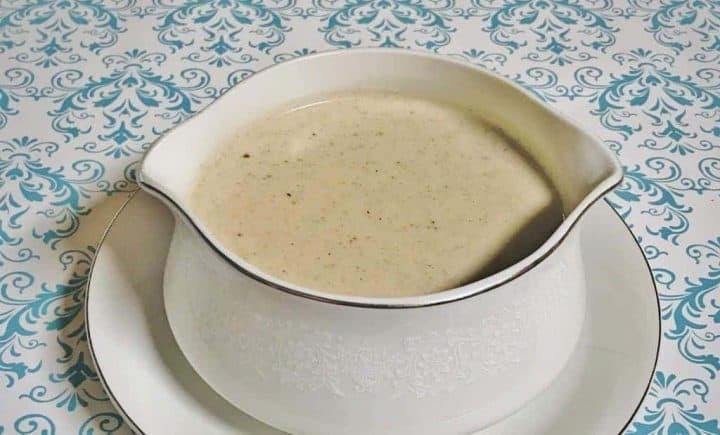 Creamy white country gravy in a white gravy bowl.