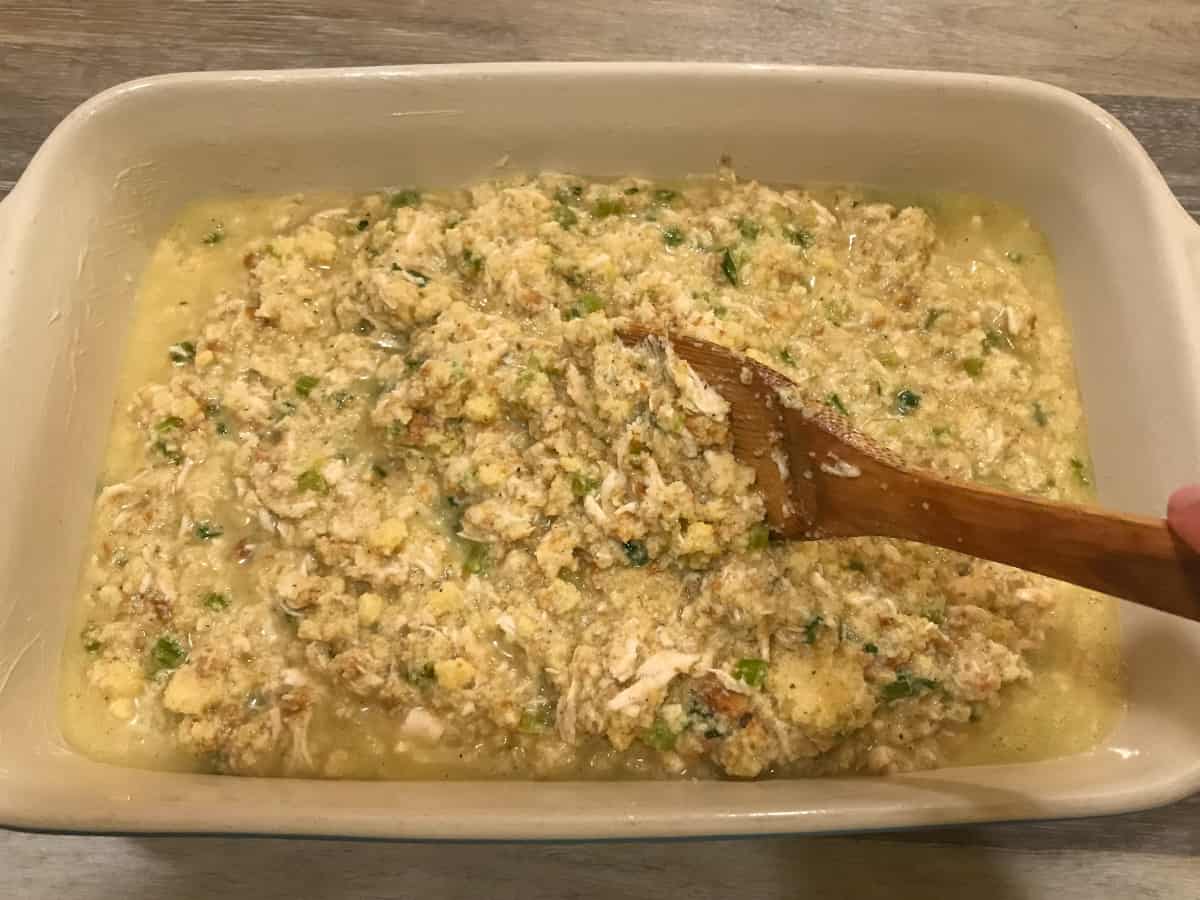 All ingredients of Chicken and Dressing mixed together in a large casserole dish.