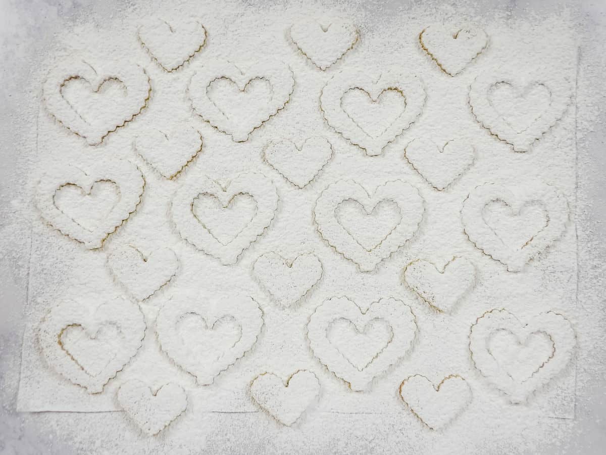 Heart shaped cookie cutouts dusted with powdered sugar.