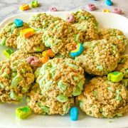Cooked green chocolate chip oatmeal cookies on a white plate.