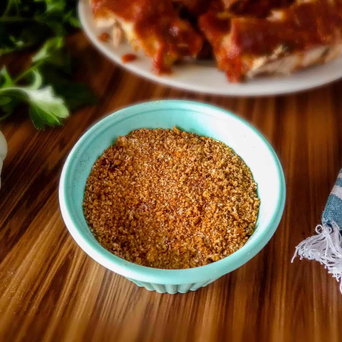 Sweet Dry Rub for Pork Ribs in a blue bowl on a brown wooden table.