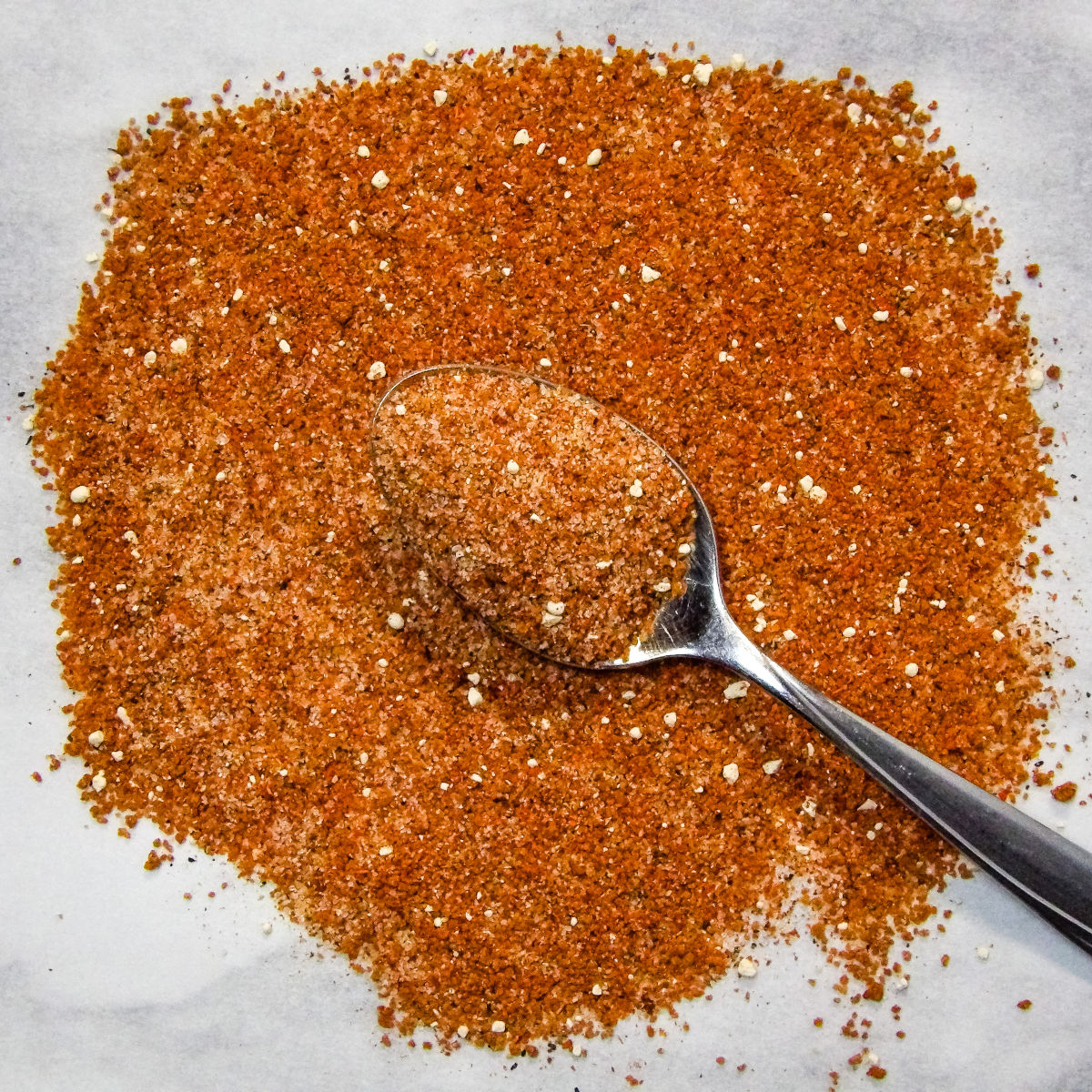 Sweet Dry Rub for Pork Ribs on a silver spoon.