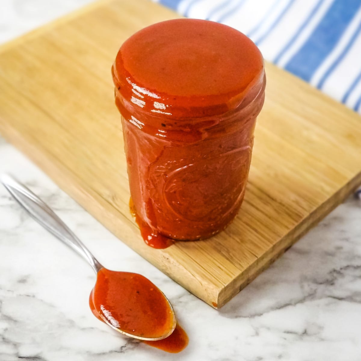 Homemade barbecue sauce in a glass jar.