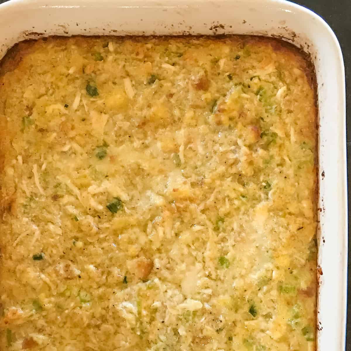 Cooked Chicken and Dressing in a casserole dish.