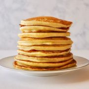 A stack of leftover mashed potato pancakes laying on a white plate.