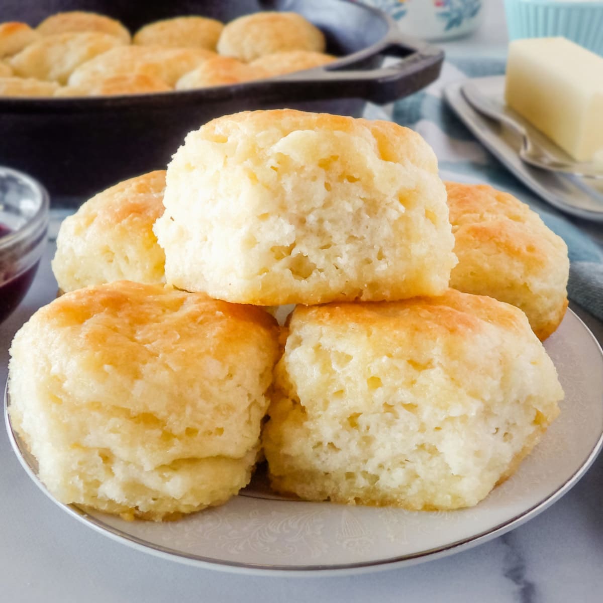 Baked homemade biscuits on a white plate.