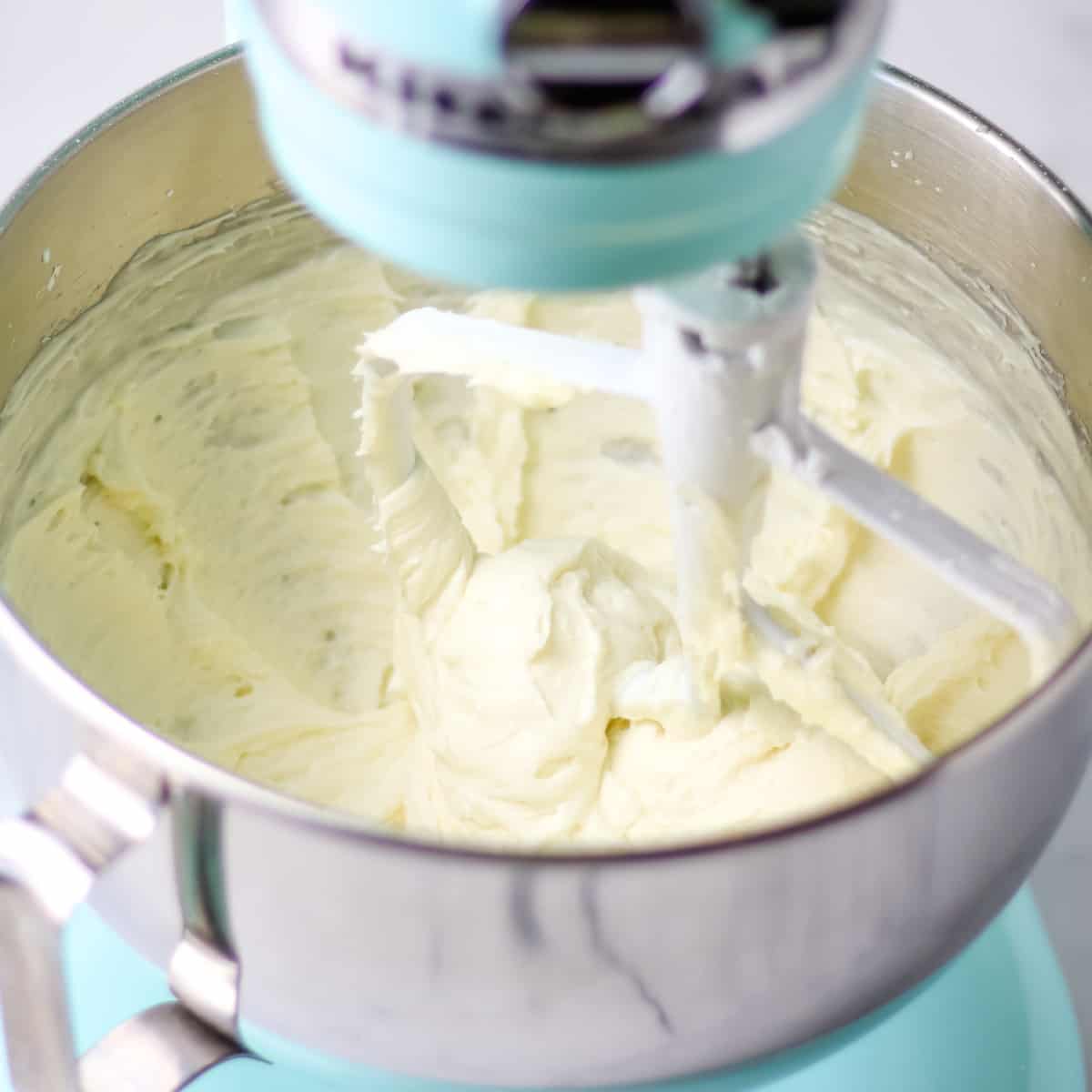 Homemade cream cheese frosting in an electric stand mixer.