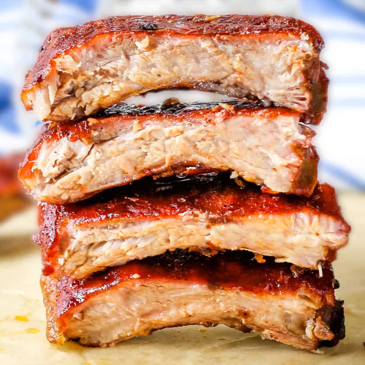 Sliced baby back ribs stacked on top of each other.
