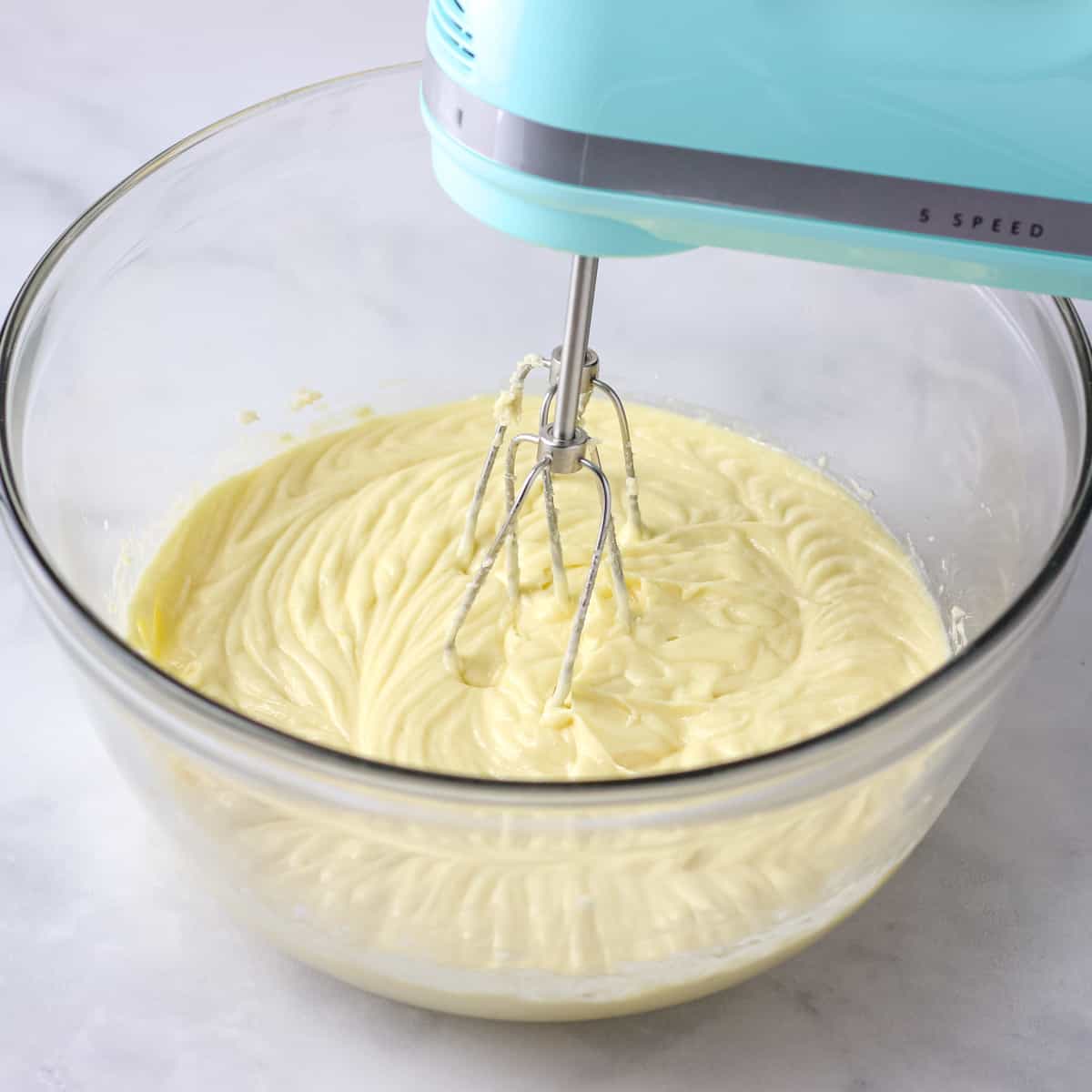 Mixing the wet ingredients together in a large glass bowl.