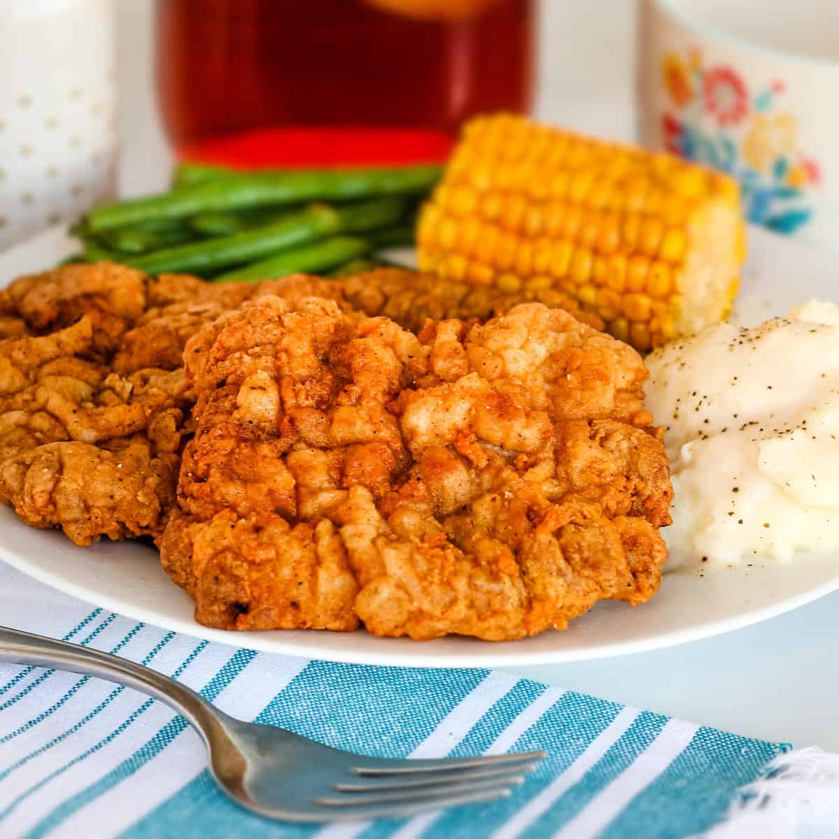 Chicken fried deer steak on a white plate.