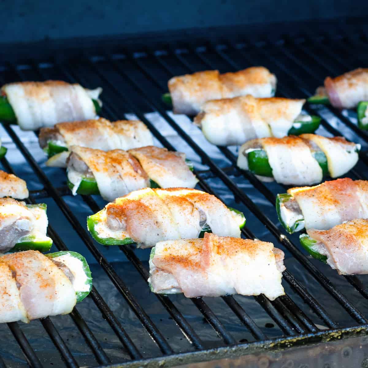 Venison jalapeno poppers smoking in a pellet grill.