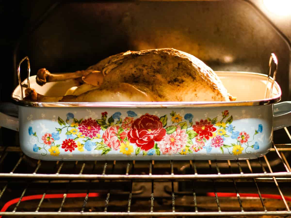 Baking the turkey in the oven uncovered.