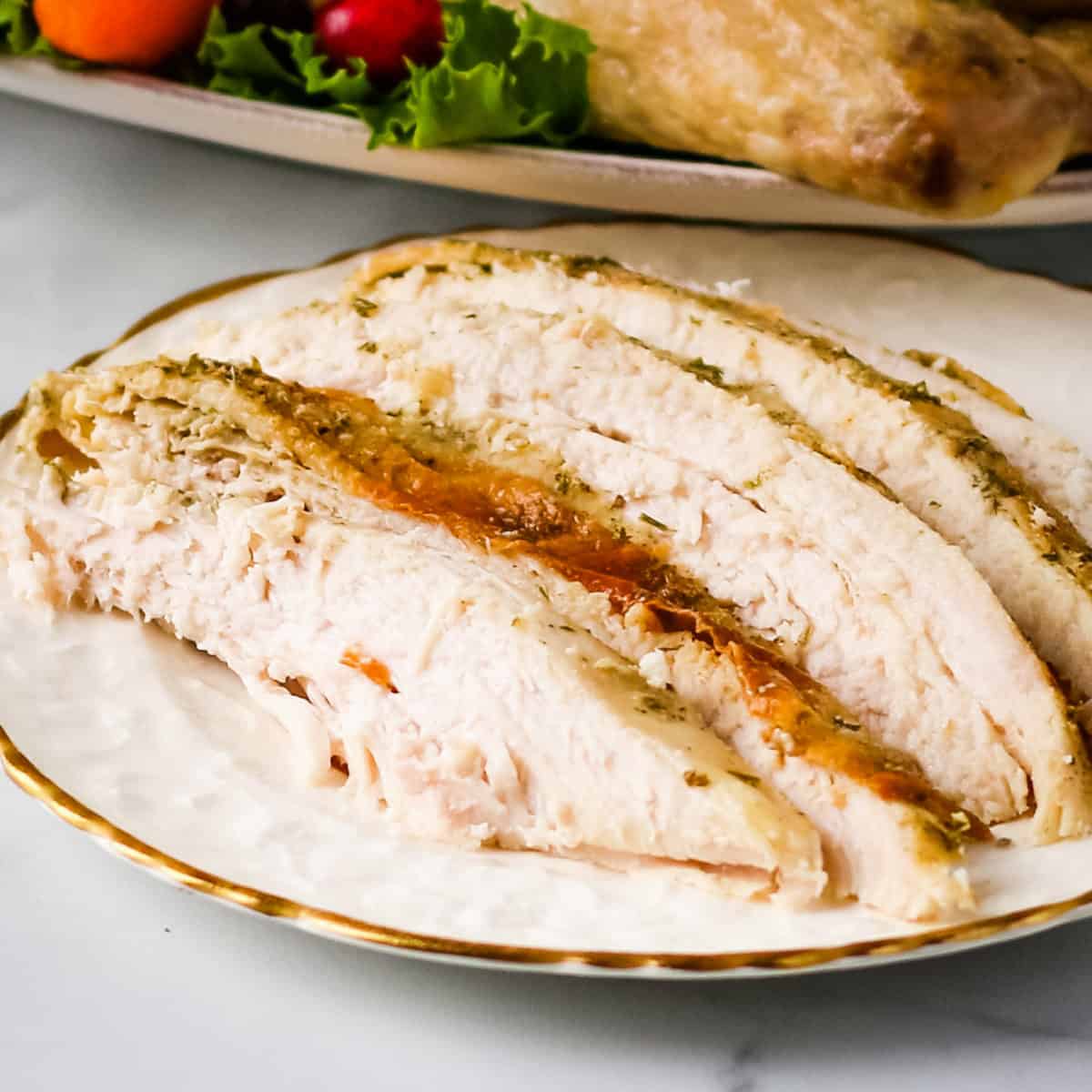 Sliced turkey on a white plate.