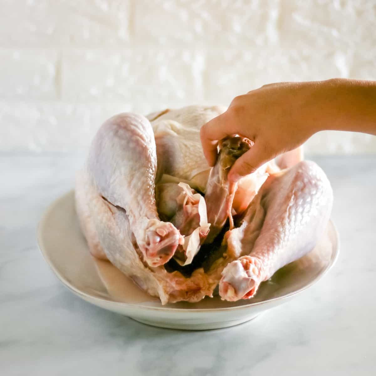 Pulling the neck out of the turkey cavity.