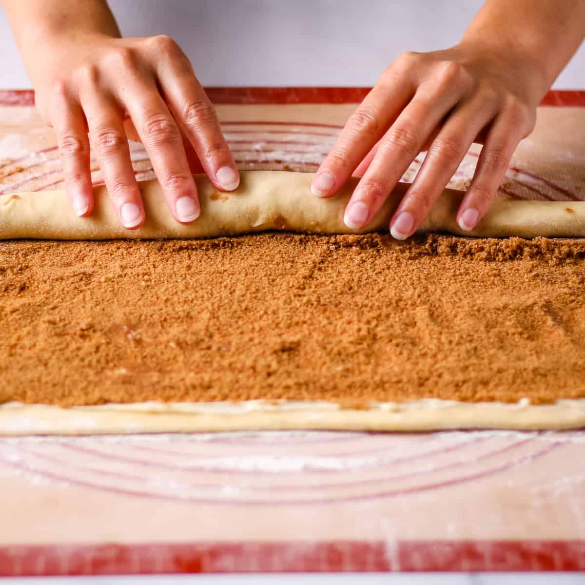 Tightly rolling up the dough into a log.