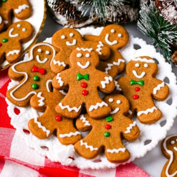 Homemade gingerbread cookies decorated in royal icing on a white plate.