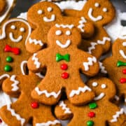 Homemade gingerbread cookies decorated in royal icing on a white plate.