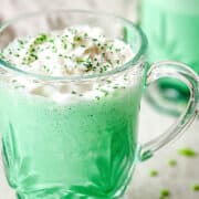 Green shamrock shake in a glass cup.