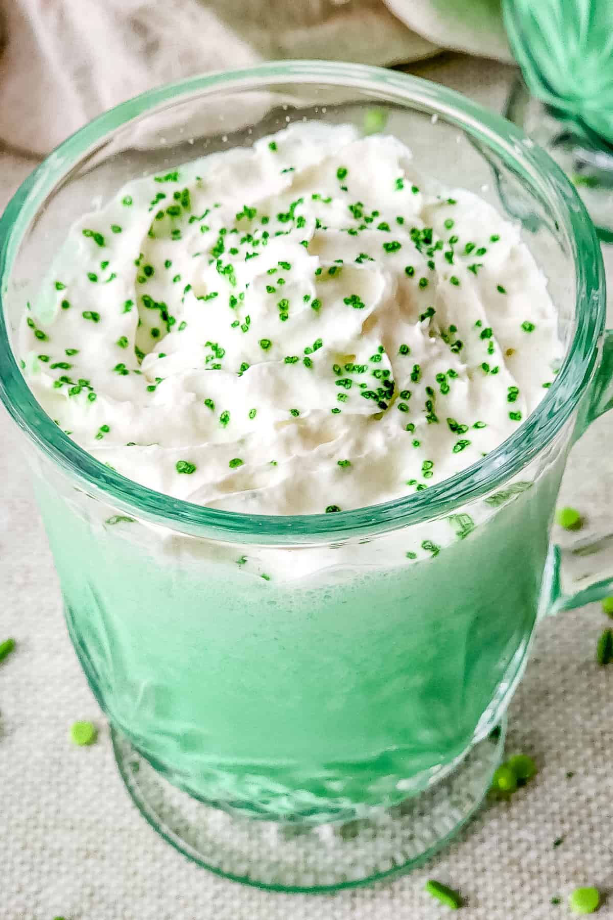 Green shamrock shake in a glass cup.