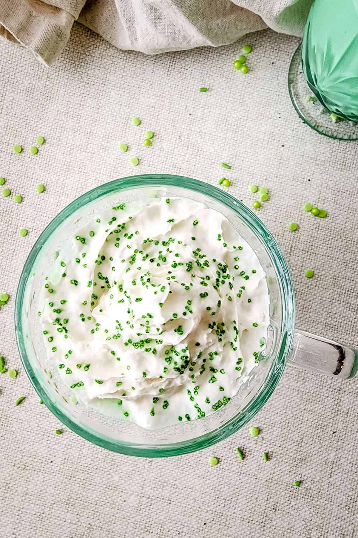 Green shamrock shake in a glass cup.