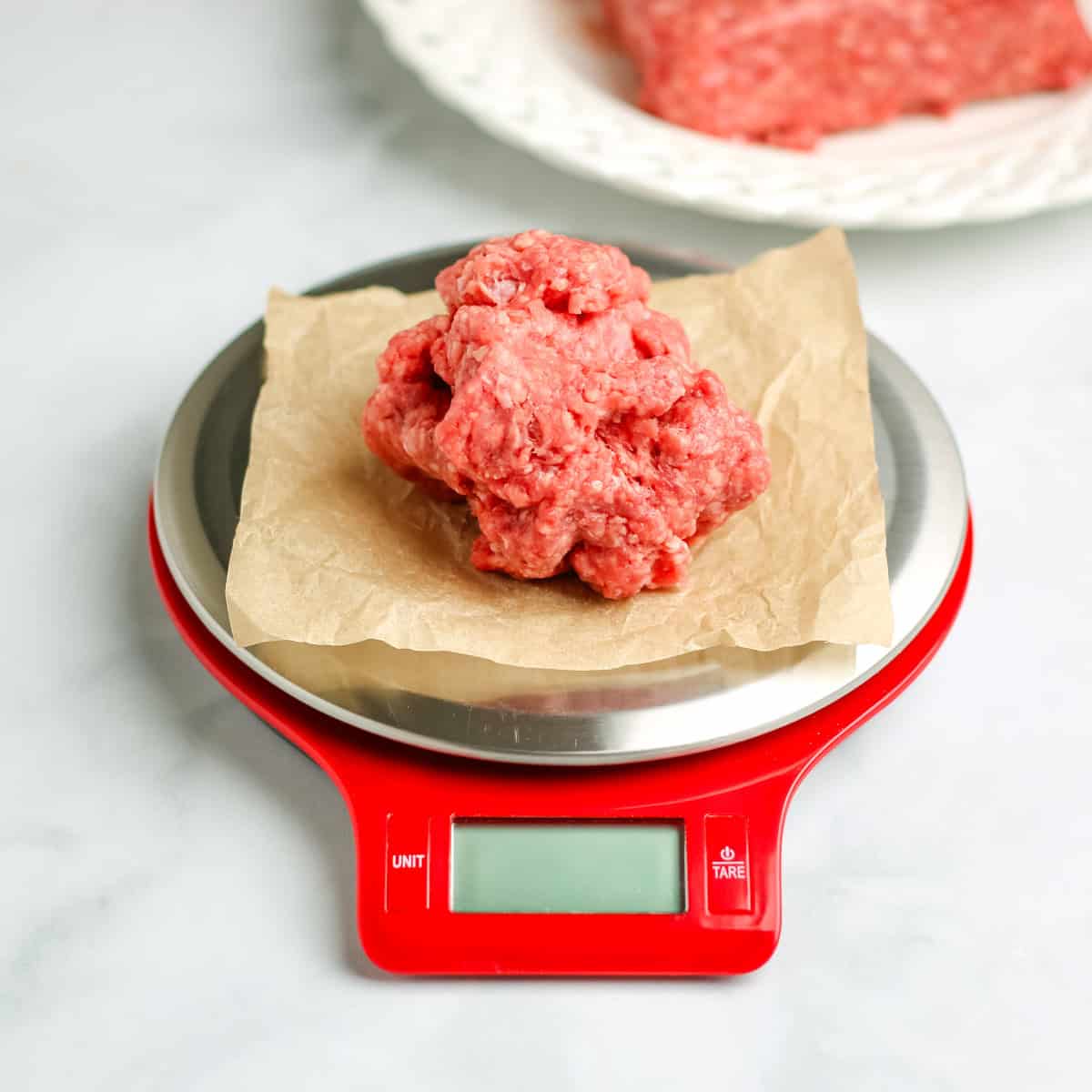 A portion of ground beef on a digital food scale.