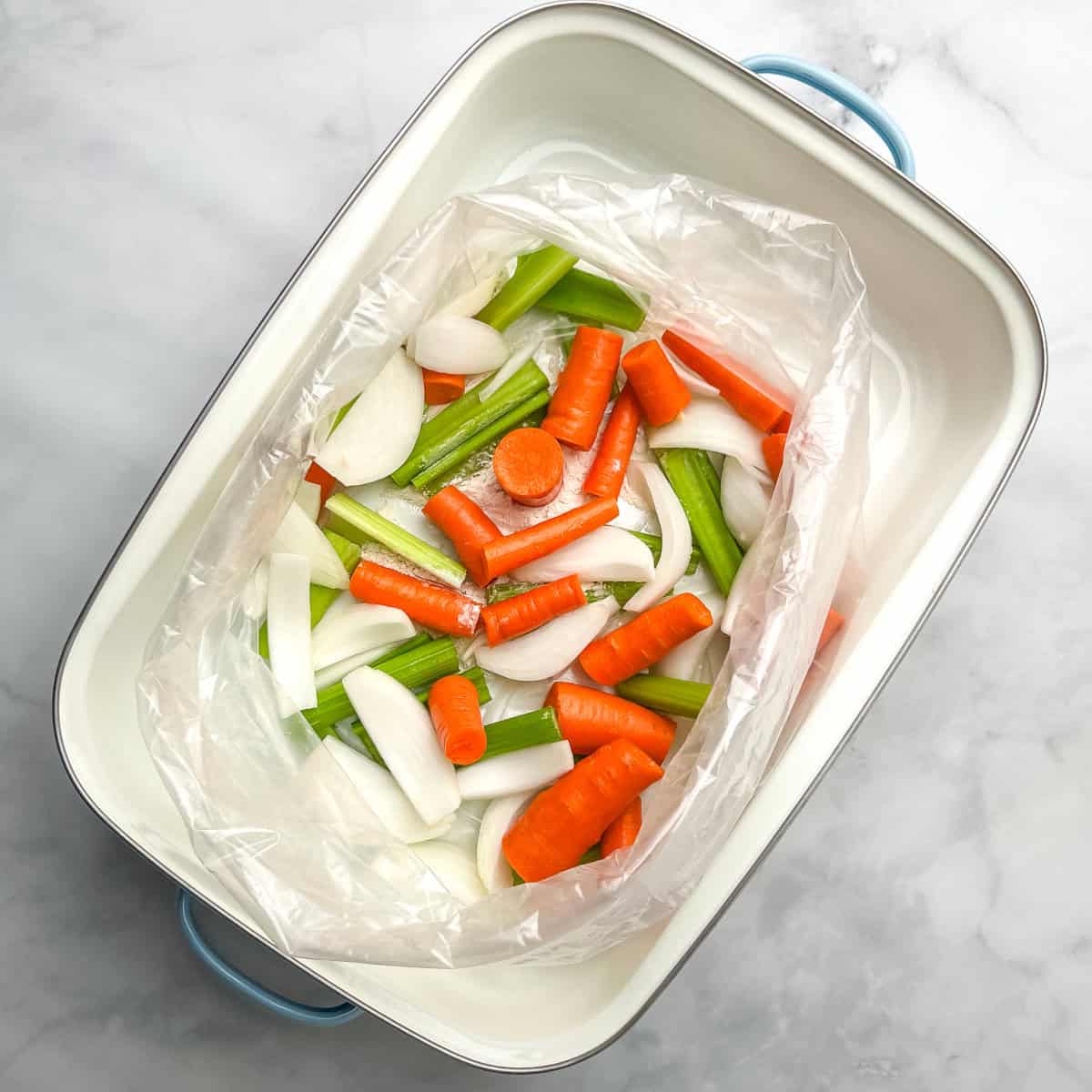 Rough chopped celery, carrots, and onion in the bottom of an oven bag in a large roasting pan.
