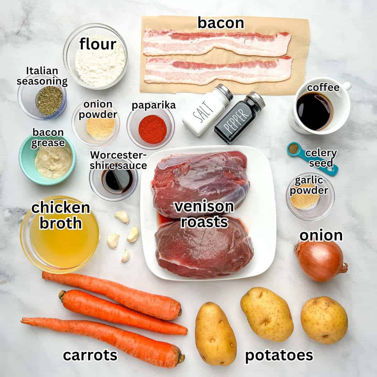 Labeled ingredients for slow cooker venison roast recipe on a white marble countertop.